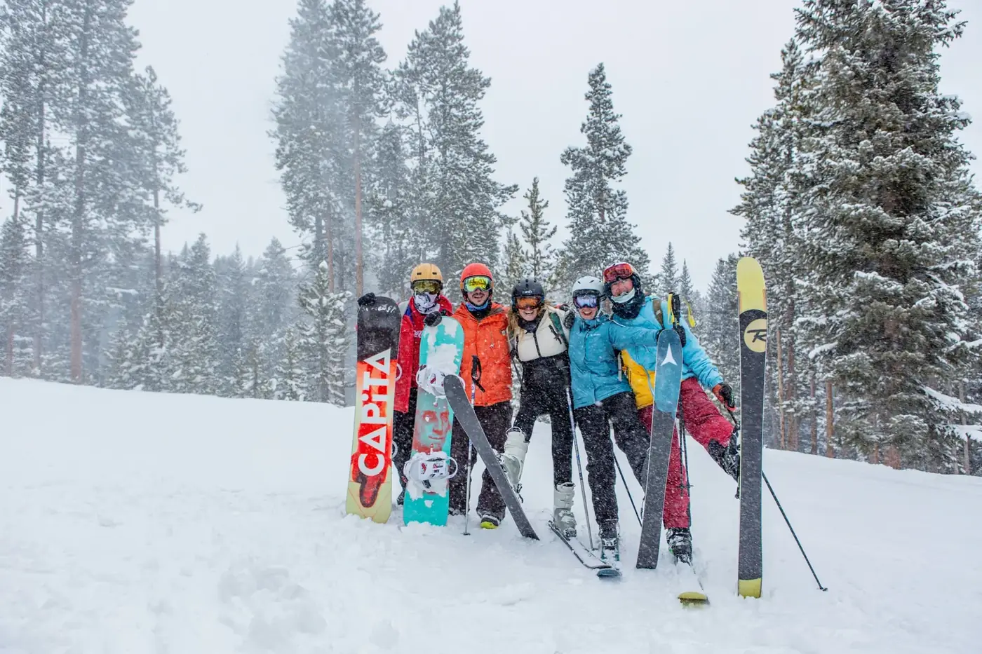 Friends on skis and snowboards in a snowstorm